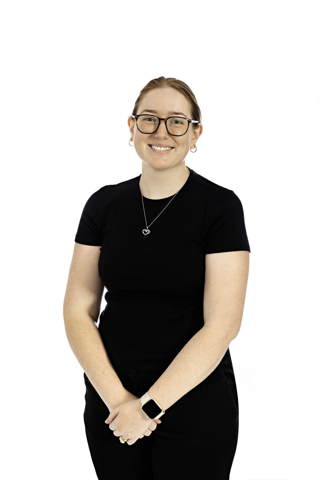 Smiling person wearing black shirt and glasses in studio lighting