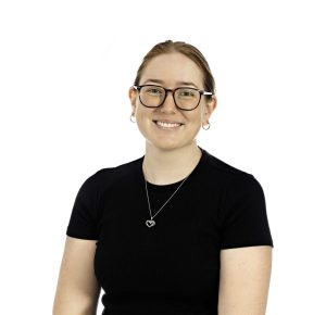 Smiling person wearing black shirt and glasses in studio lighting