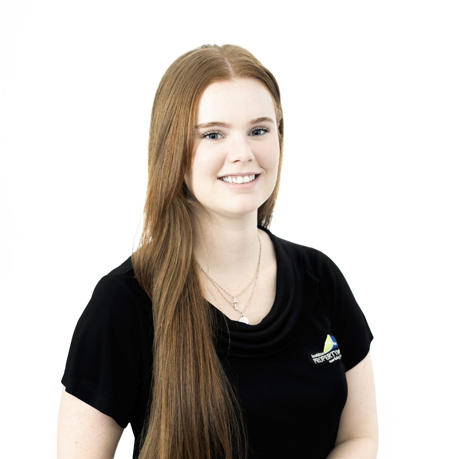 Young woman with long hair smiling in black shirt against white background
